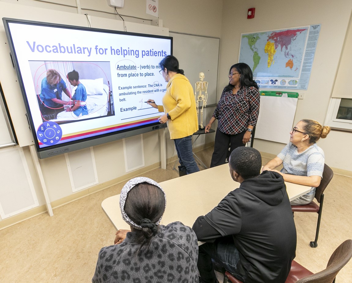 A student writes on a projector