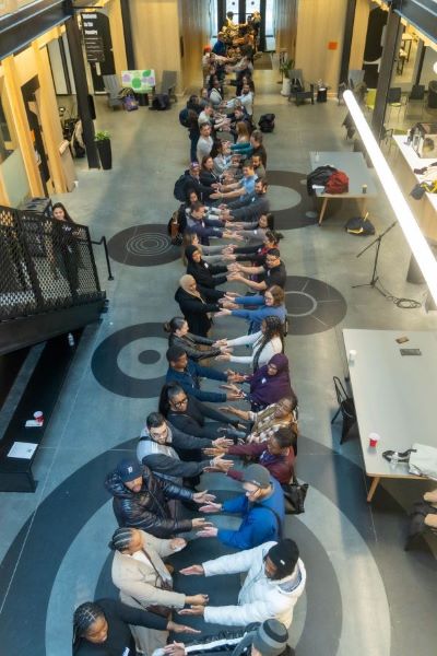 An aerial shot of OST professionals holding hands