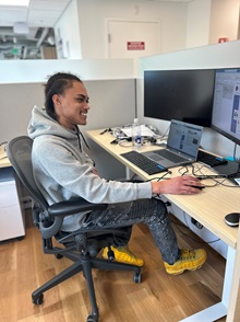 Person smiling while working at a computer