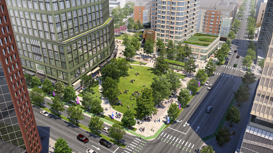 Artist's rendering of the transformed Volpe site surrounded by modern buildings, with people walking and relaxing on the grass, and cars on nearby streets.