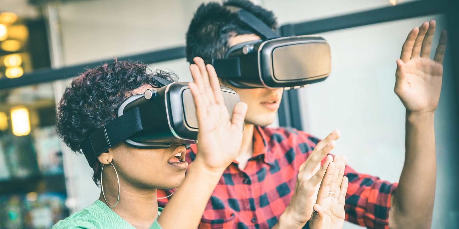 Photo of two people wearing VR goggles