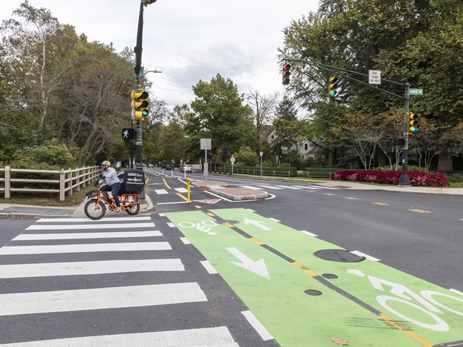 Separated 2 way bike lane with biker at brattle st