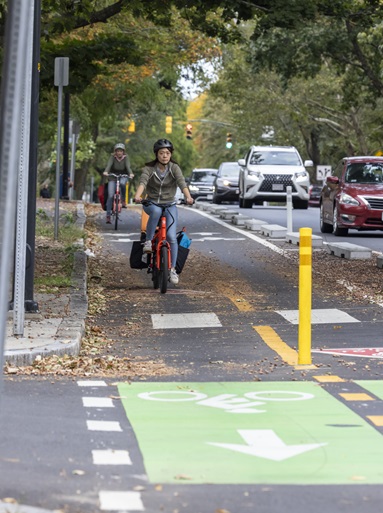 Separated 2 way bike lane with biker at brattle st