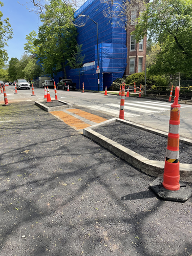 A pedestrian crossing island under construction on Brattle Street