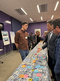 people standing around a map on the table to posted notes