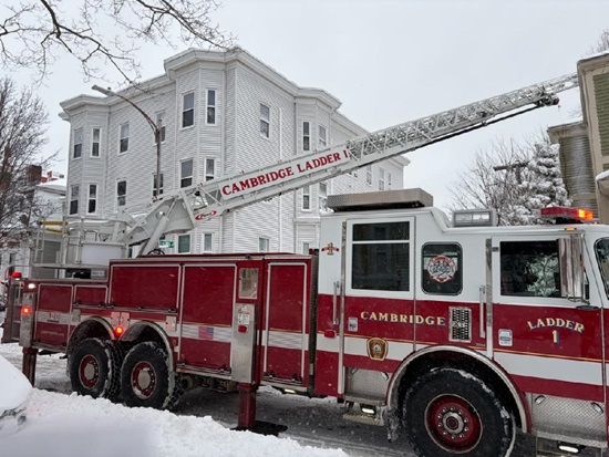 Ladder 1 with aerial ladder to the roof, - Box 413 - Inman Street during the blizzard of Feb 23, 2026