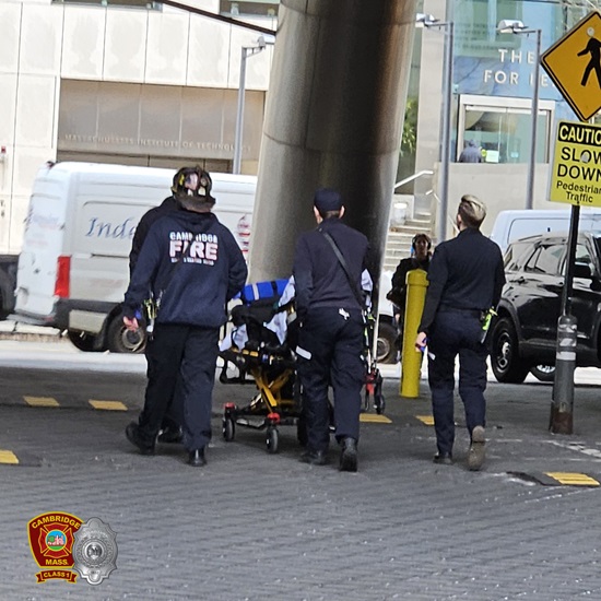 Firefighters and EMTs moving a patient for medical evalaution following rescue from a disabled scaffolding 70' high