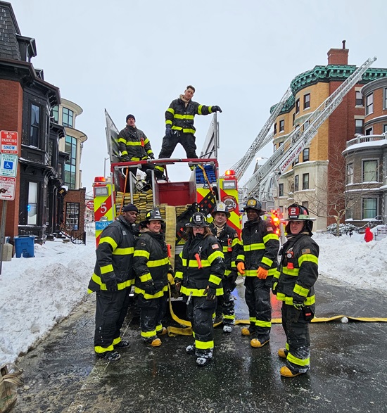 2nd alarm box 2-461 - 1137 Mass Av - firefighters repacking hose on Engine 5 pump after fire has been extinguished