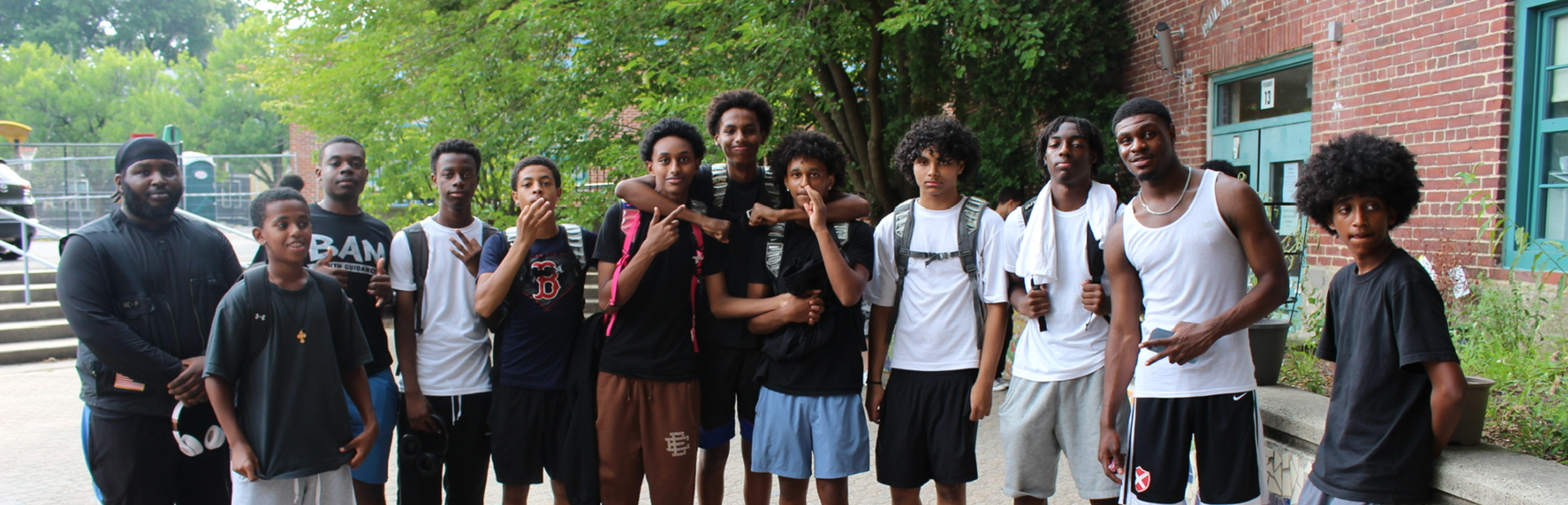 teen boys stand outside a youth center