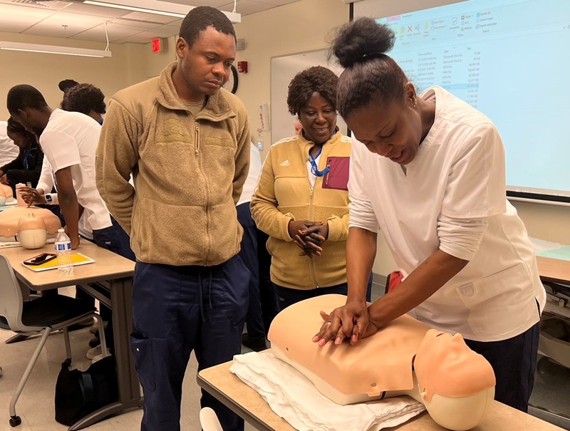 A participant in the CNA Training for English Language Learners Program practices CPR.