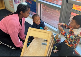 A Cambridge early educator engages with preschoolers