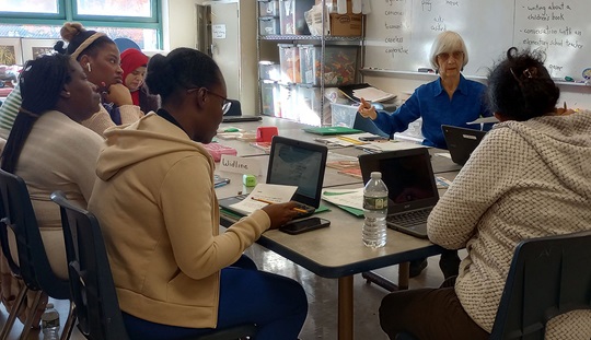 CLC students study at a table in the Parents with Young Children English class