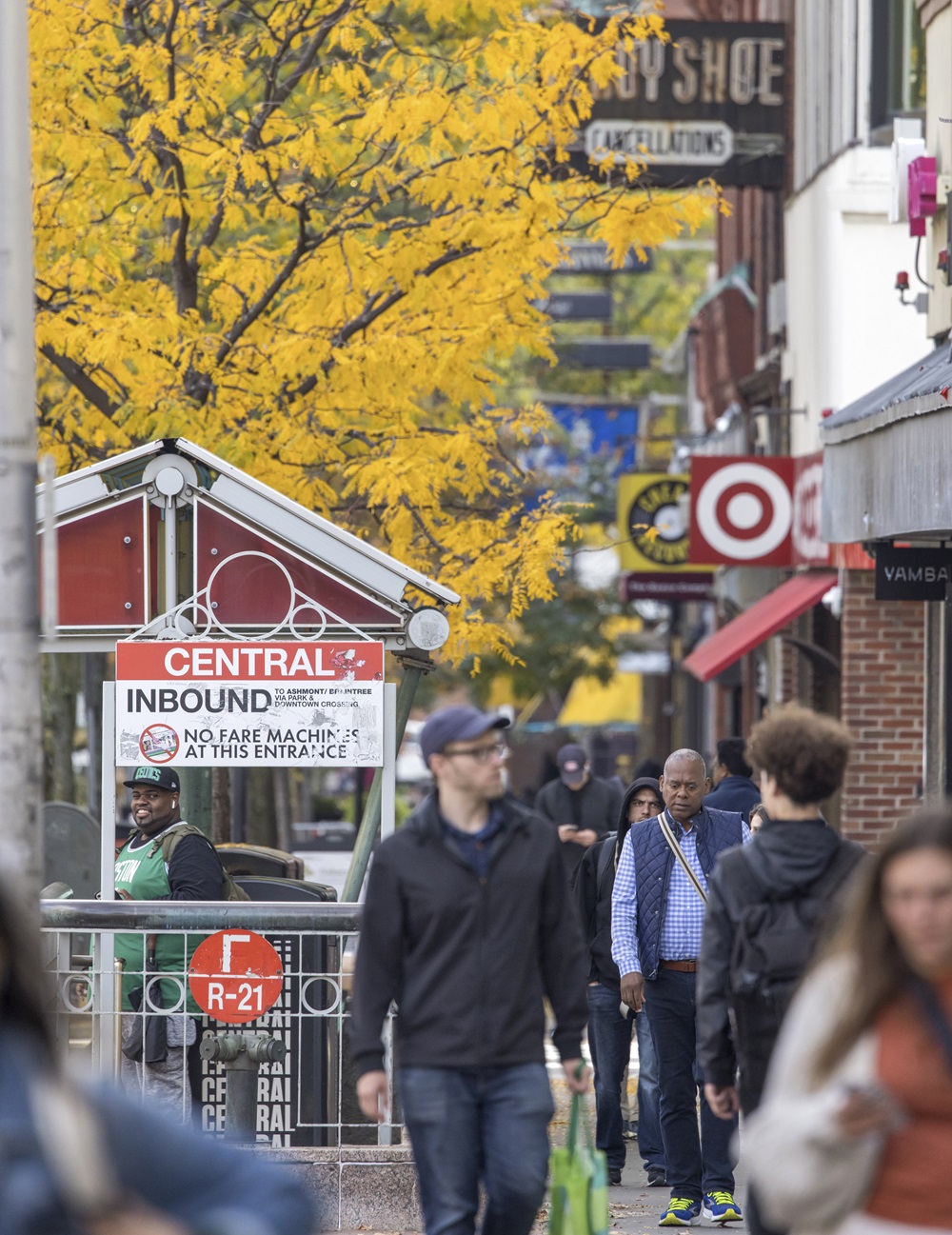 Pedestrians walk in Central Square during the fall.