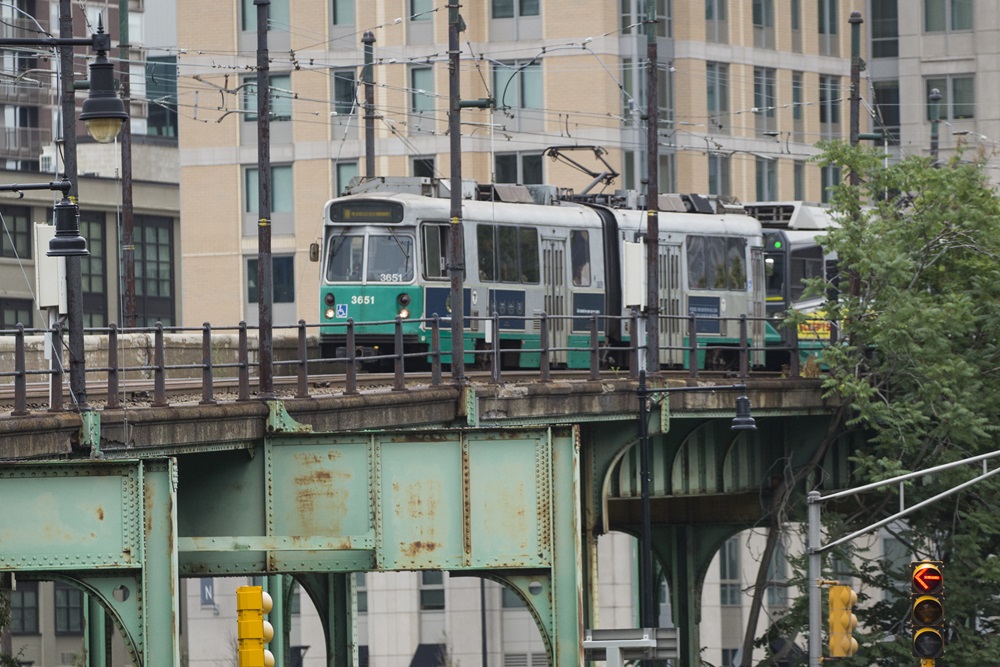 An MBTA green line train travels towards Lechmere station