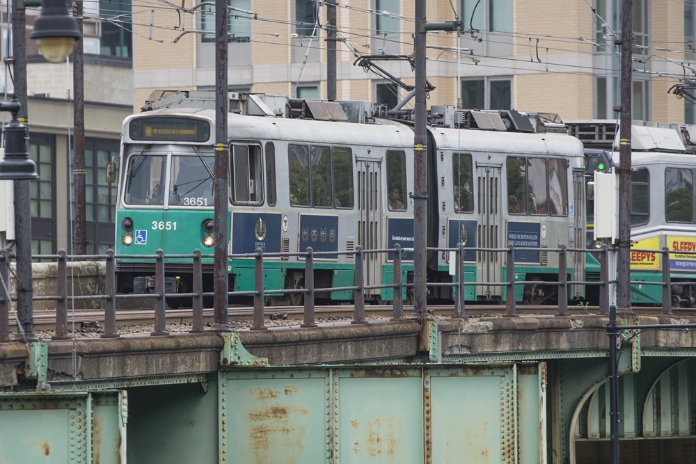 An MBTA green line train travels towards Lechmere station