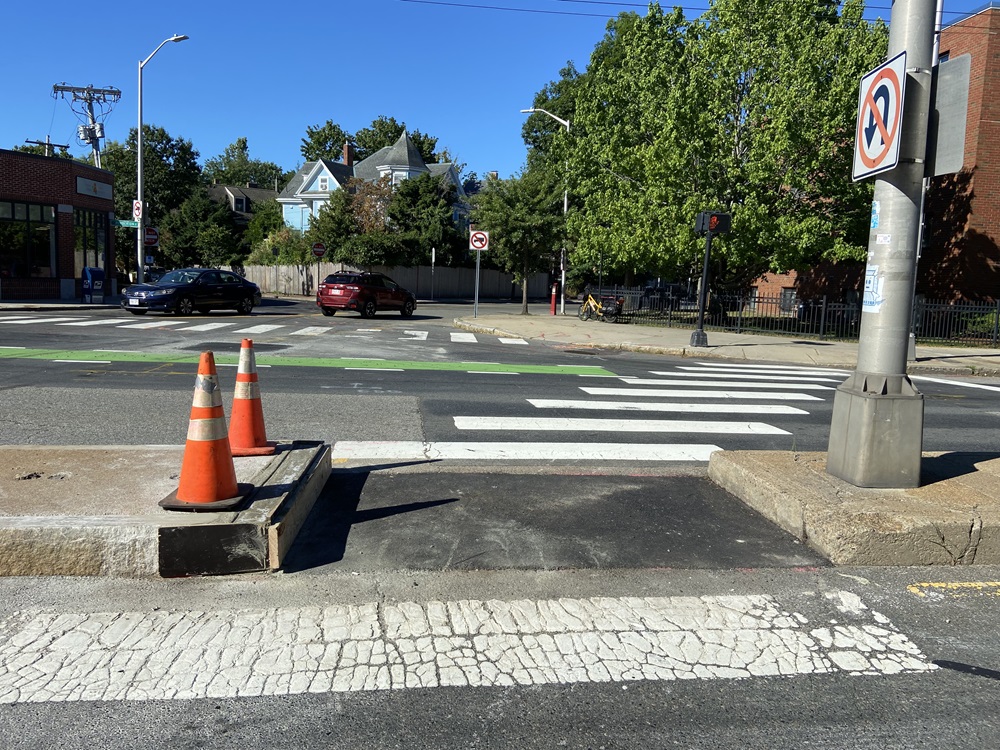 Construction is done at a crosswalk on Mass Ave and Rindge Ave, so it could be widened for pedestrians.