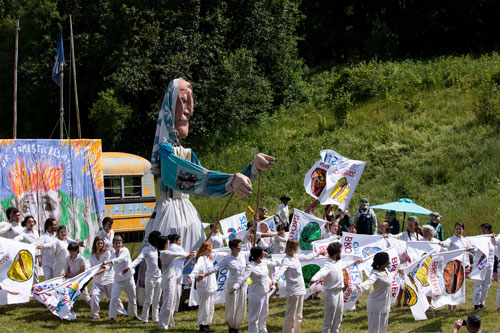 A giant washerwoman puppet and actors perform Bread & Puppet Theater's 2022 "Our Domestic Resurrection Circus: Apocalypse Defiance" at their Glover, Vermont, farm.