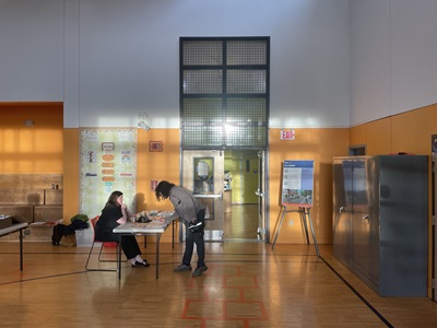 Basketball gym with person signing in at front door