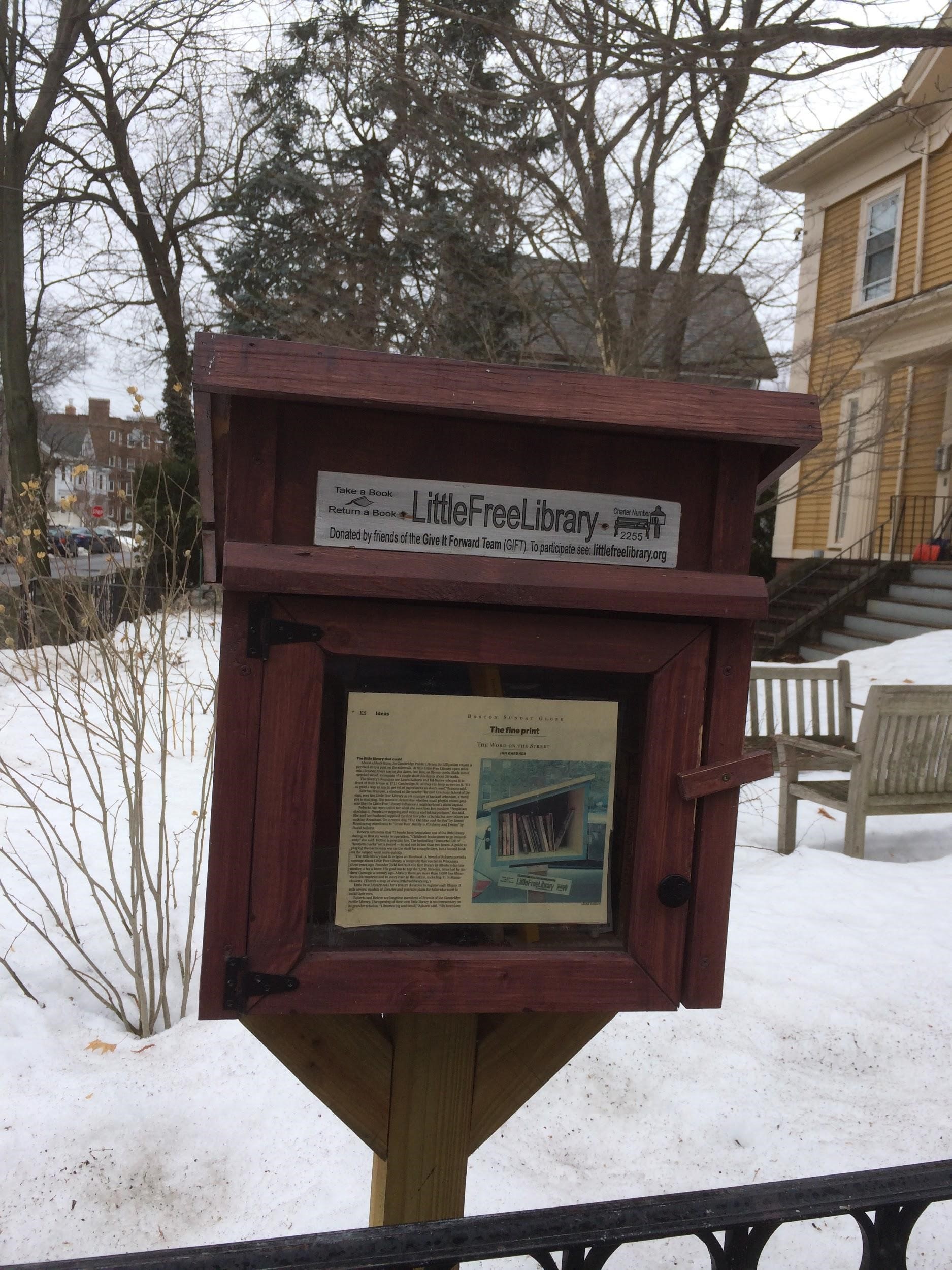 Newspaper article displayed in a Little Free Library