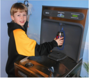 Boy filling his water bottle at a filling station