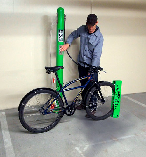 Man washing his bike at wash station inside a garage