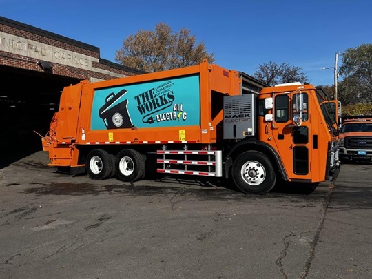 All electric trash truck with department of public works logo