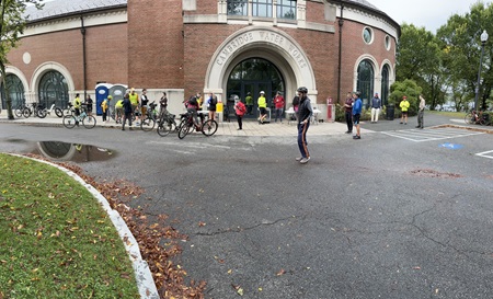 Riders stand in front of the Water Treatment plant and prepare for the bike ride