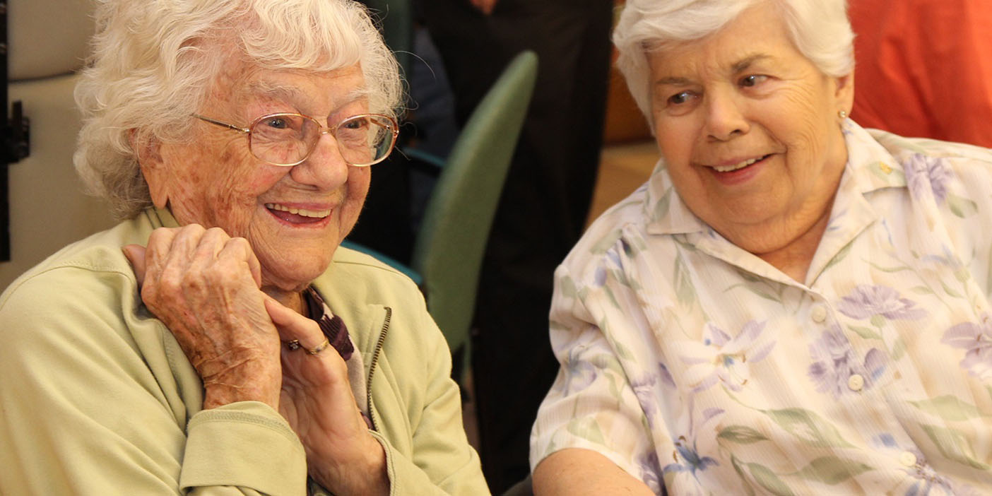 Two senior citizens smiling